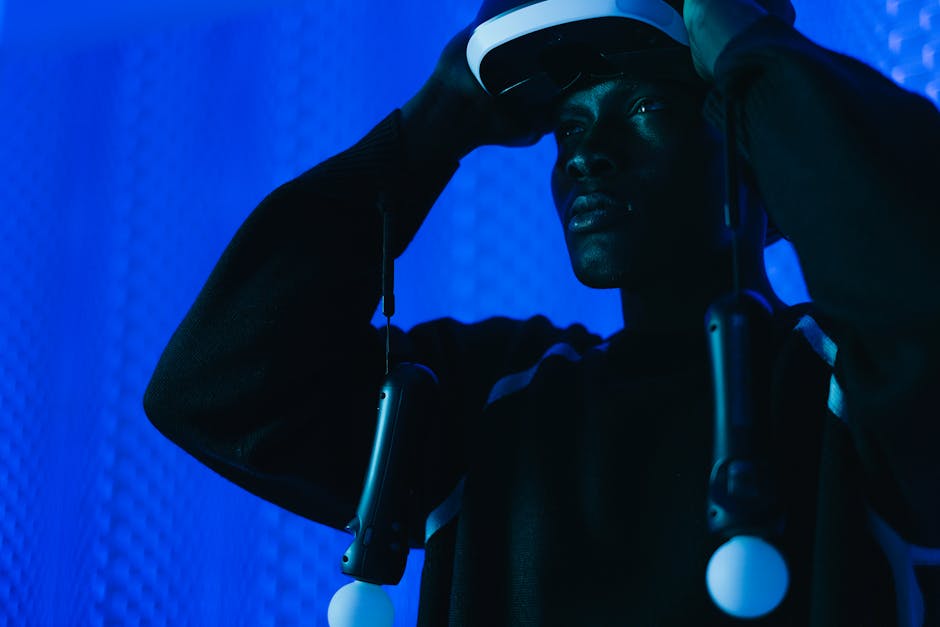 A group of diverse professionals collaborating in a modern office setting with laptops and technology.