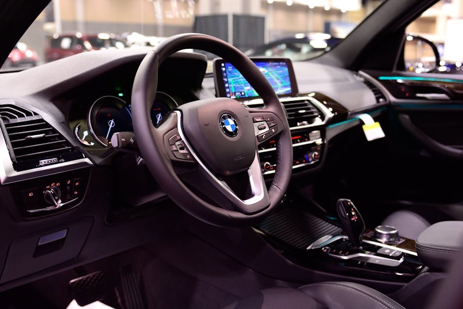 A diverse group of professionals working together on laptops in a modern office meeting room.