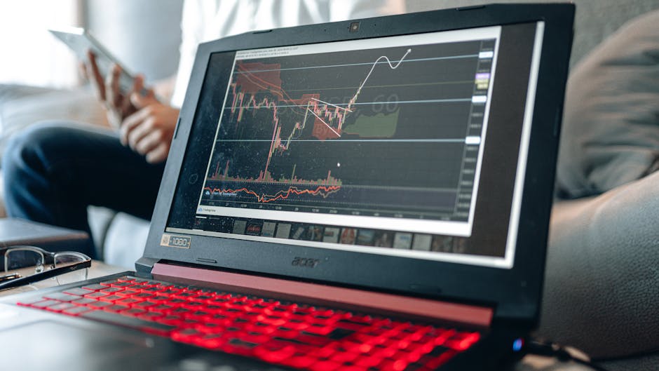 A diverse group of professionals working together on laptops in a modern office meeting room.