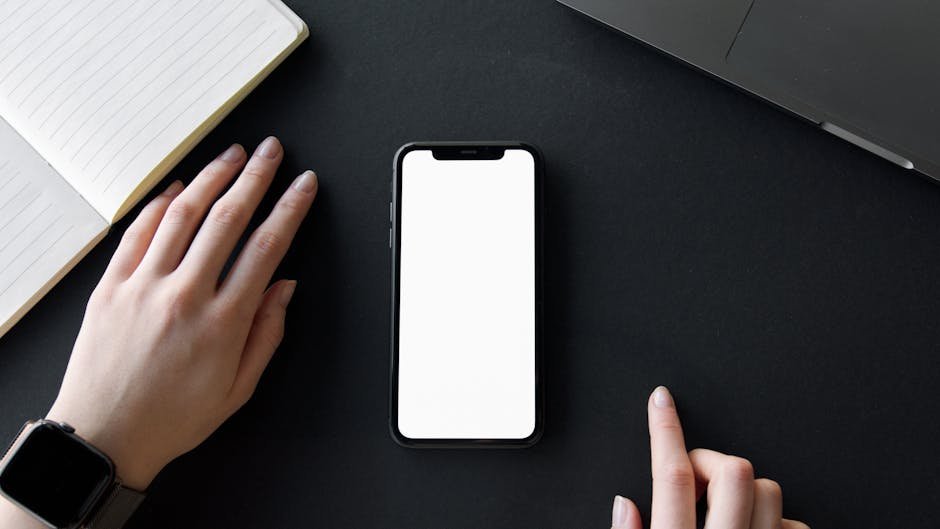 A diverse group of professionals working together on laptops in a modern office meeting room.