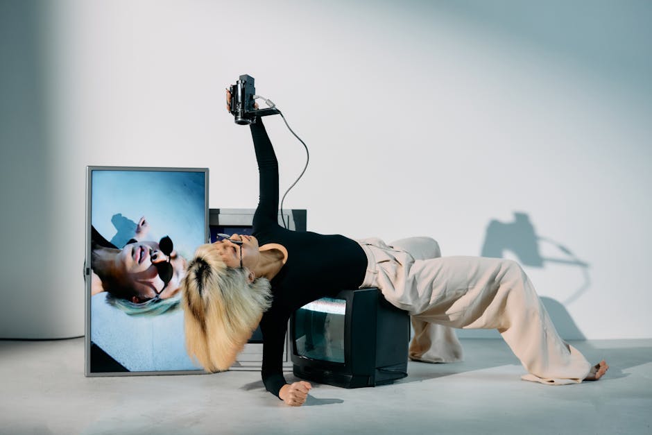 Stylish woman posing with vintage CRTs in a modern editorial photoshoot.
