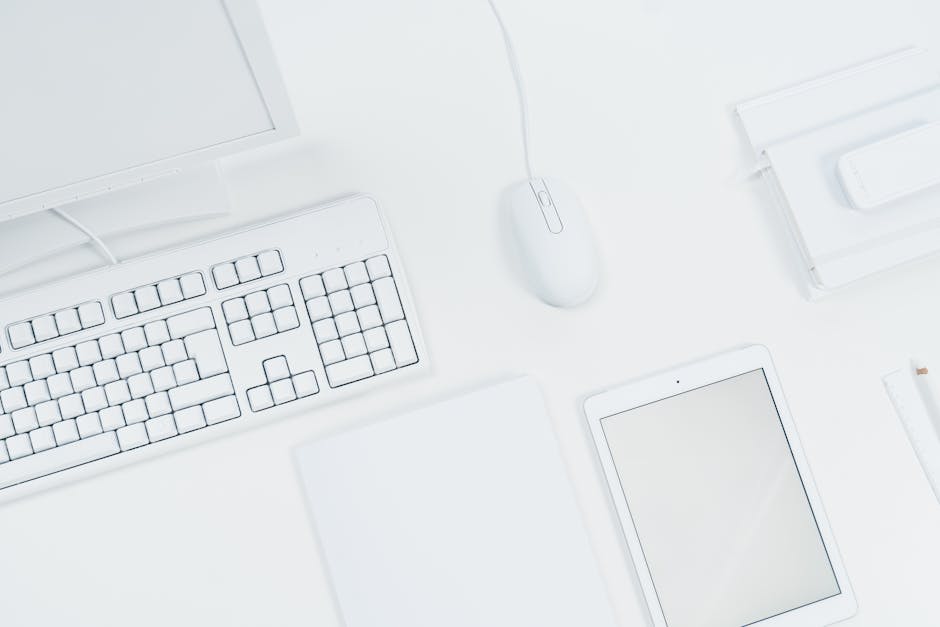 A group of diverse professionals collaborating in a modern office setting with laptops and technology.