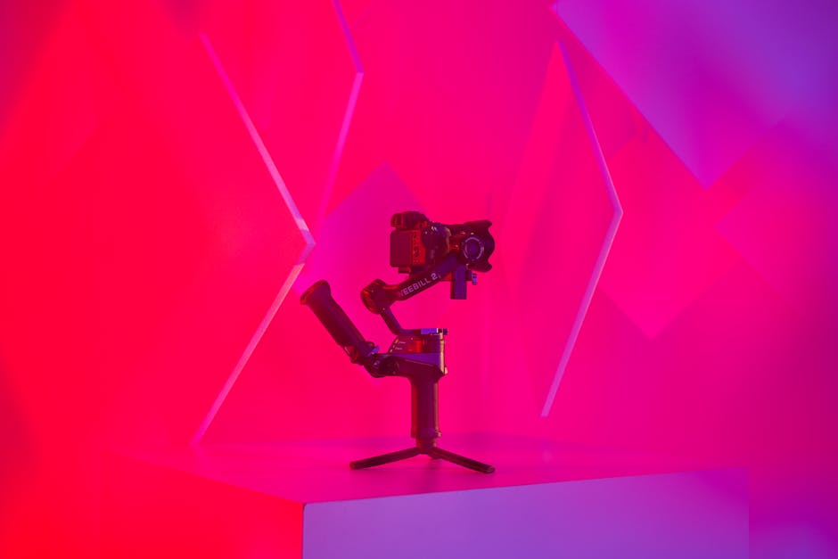 Vibrant studio image featuring a modern camera gimbal setup against abstract color background.