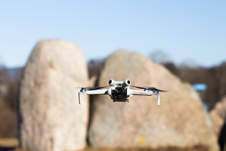 Aerial drone captured mid-flight with blurred stone background in Jönköping, Sweden.