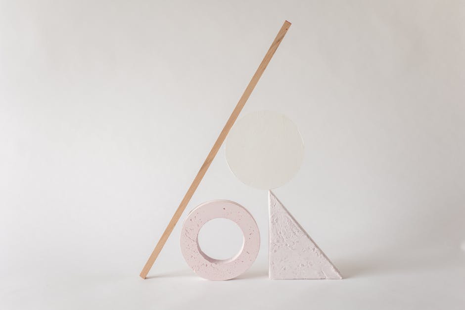 Elegant minimalist arrangement of abstract geometric shapes on a light neutral background.