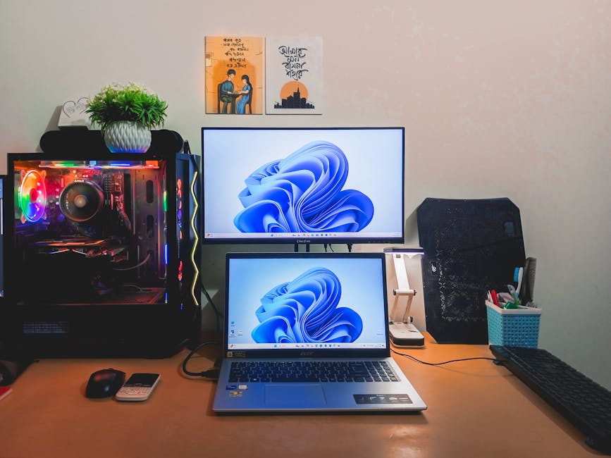 A clean and organized computer desk setup with dual screens in a modern workspace.