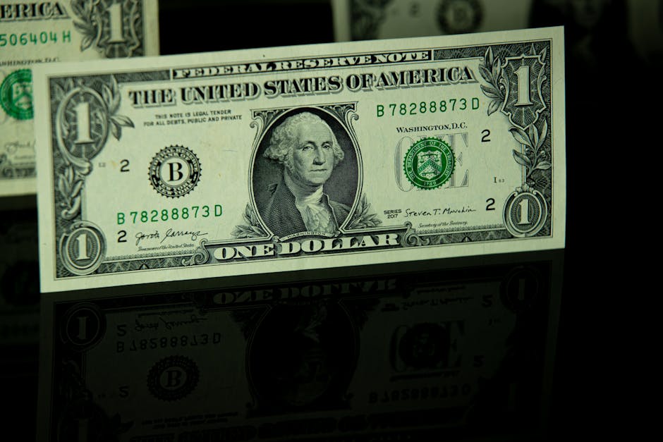 A group of diverse professionals collaborating in a modern office setting with laptops and technology.