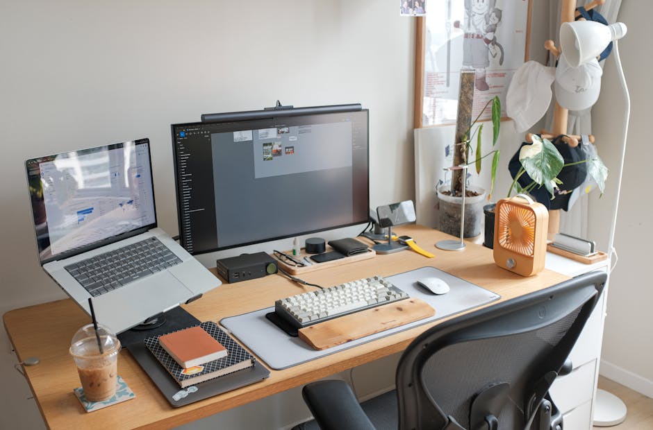 A sleek office setup featuring a laptop, monitor, and stylish accessories enhancing productivity.