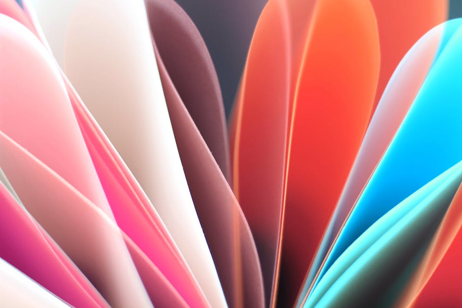 Dynamic abstract composition of colorful folded paper sheets with vibrant hues.