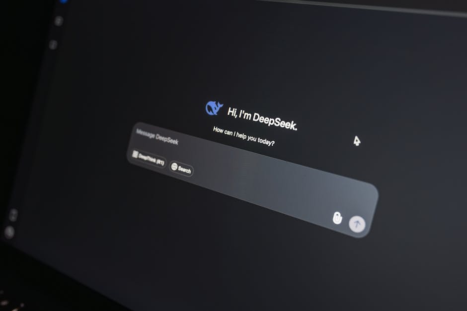 Close-up of DeepSeek AI chat interface on a laptop screen in low light.