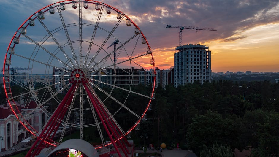 A breathtaking view of a Ferris wheel against a colorful sunset in Kharkiv, Ukraine.