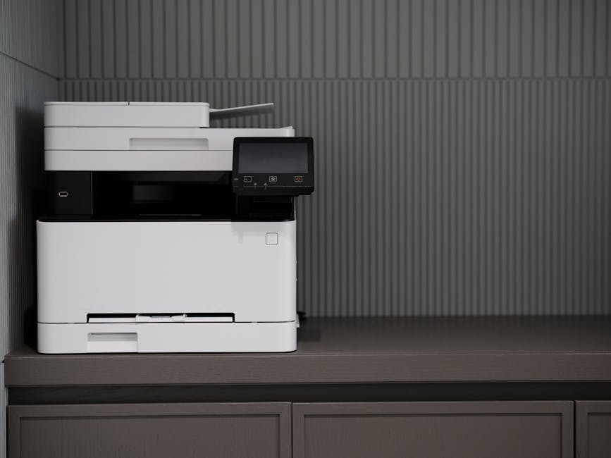 A sleek, modern printer situated on a minimalist office desk with a textured background.