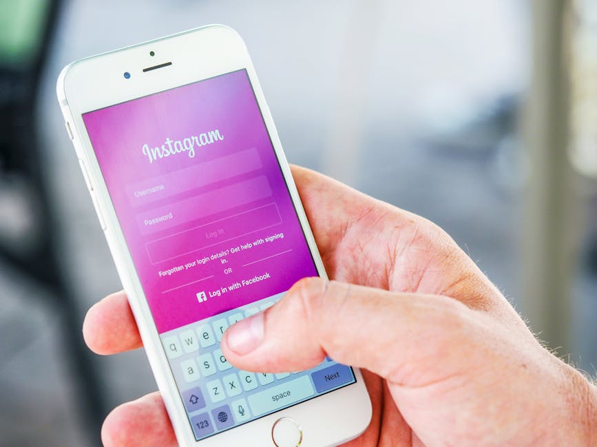 Close-up of a hand holding a smartphone displaying the Instagram login screen, highlighting mobile technology.