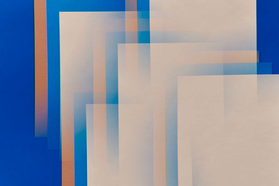Abstract geometric composition with layered rectangles on a vibrant blue background, showcasing modern art style.